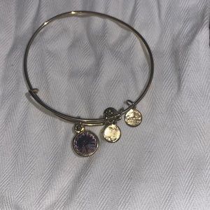 Gold Alex and Ani bracelet with pink gem